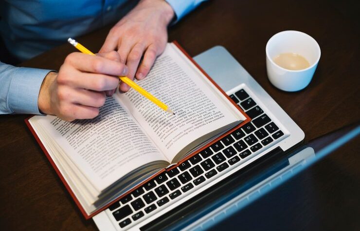 crop-man-studying-near-laptop_23-2147779362