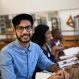 hes-happy-about-task-they-received-portrait-university-student-sitting-class_590464-16228