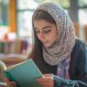 middle-eastern-girl-reading-her-notebook-with-colorful-educational-materials-scattered-around-her_220770-106533