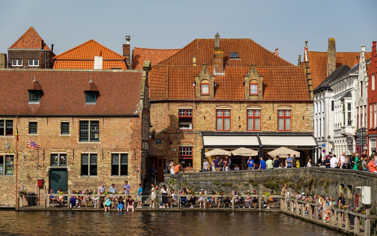 International students walking through a Belgian university campus with historic architecture