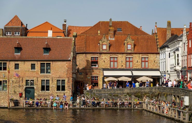 International students walking through a Belgian university campus with historic architecture
